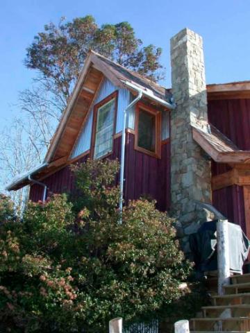 Exterior with stone chimney of West Coast Home on Pender Island built by Dave Dandeneau of Gulf Islands Artisan Homes
