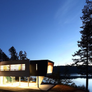 Modern Steel West Coast fusion building exterior at night on Pender Island built by Dave Dandeneau of Gulf Islands Artisan Homes